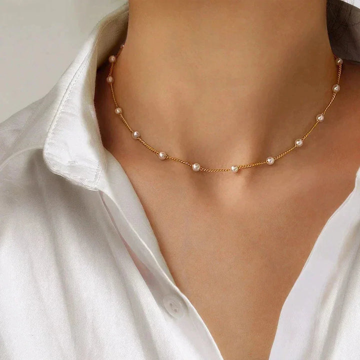 Women's gold-tone dainty choker necklace with small, spaced pearls. Elegant fashion jewelry for delicate style.