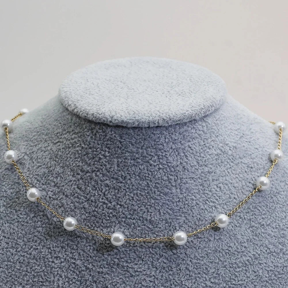 Elegant gold-tone pearl choker necklace for women, showcasing dainty spaced pearls. A stylish and delicate jewelry piece.