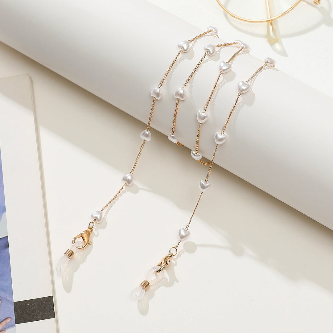 Stylish women's layered anklet featuring a pretty heart charm and delicate gold-finished chain.