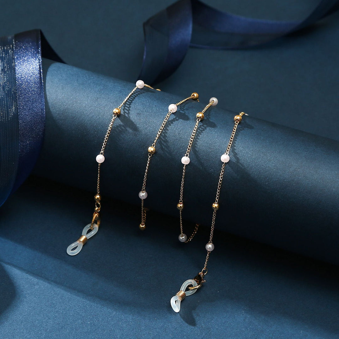 Adjustable multi-chain layered anklet with gold-tone finish and a shimmering heart pendant.