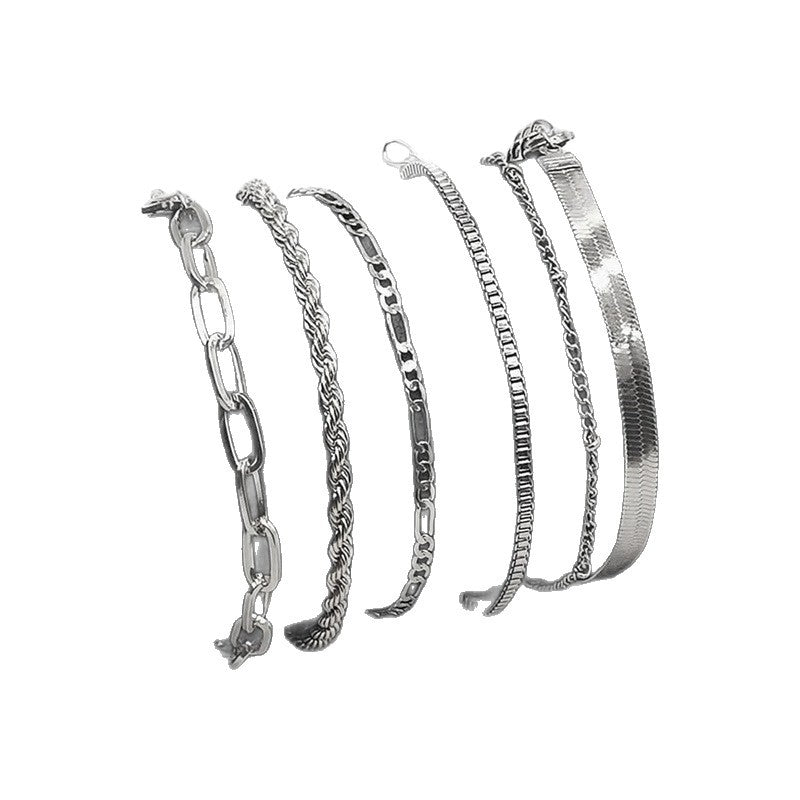 Close-up of women's gold-tone textured chain bracelet set, showcasing unique link details & craftsmanship.