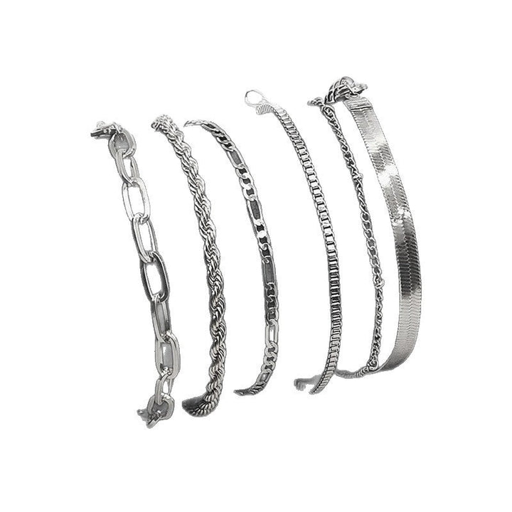 Close-up of women's gold-tone textured chain bracelet set, showcasing unique link details & craftsmanship.