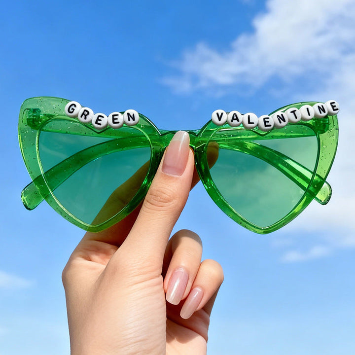 Women's gray cat-eye sunglasses with playful beaded design. Retro style eyewear offering UV protection.