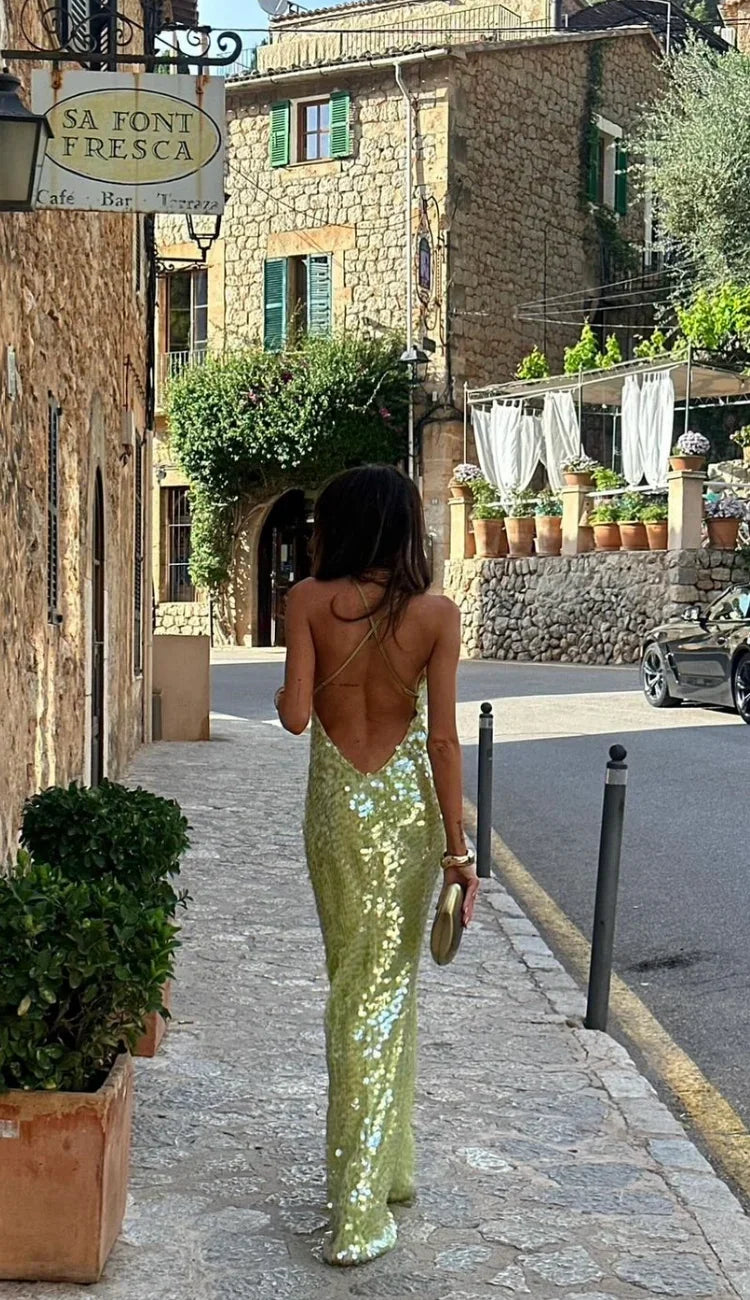 Luxurious women's green sequin backless evening maxi dress, perfect as a wedding guest or gala gown.