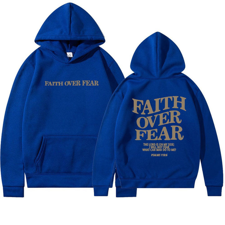 Close-up on "Faith Over Fear" text print on a women's motivational graphic hoodie.