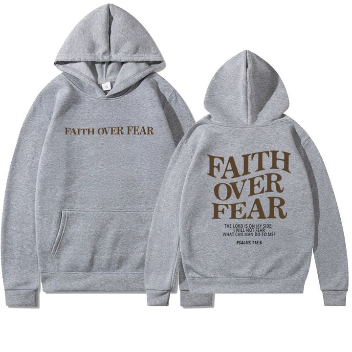 Relaxed woman in stylish "Faith Over Fear" inspirational apparel, casual wear.