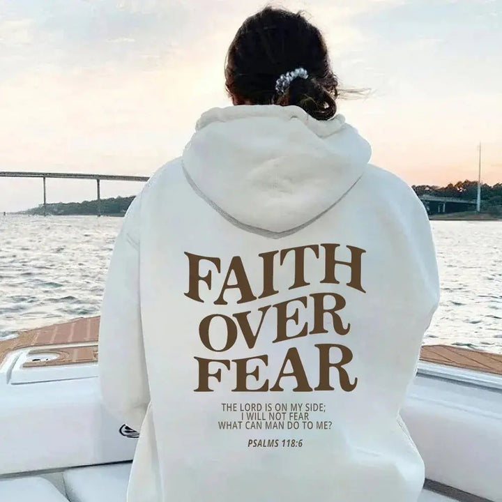 Vibrant "Faith Over Fear" women's graphic hoodie, emphasizing comfortable street style.