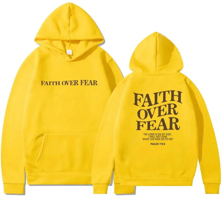 Woman smiling in a white "Faith Over Fear" inspirational graphic hoodie.