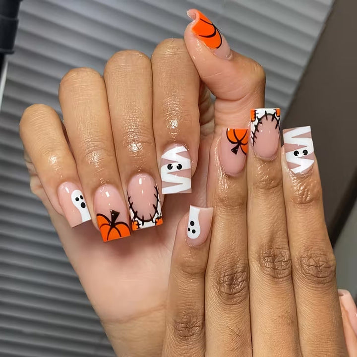 Women's Halloween press-on nail art kit with spooky pumpkins, ghosts & festive designs for easy application.