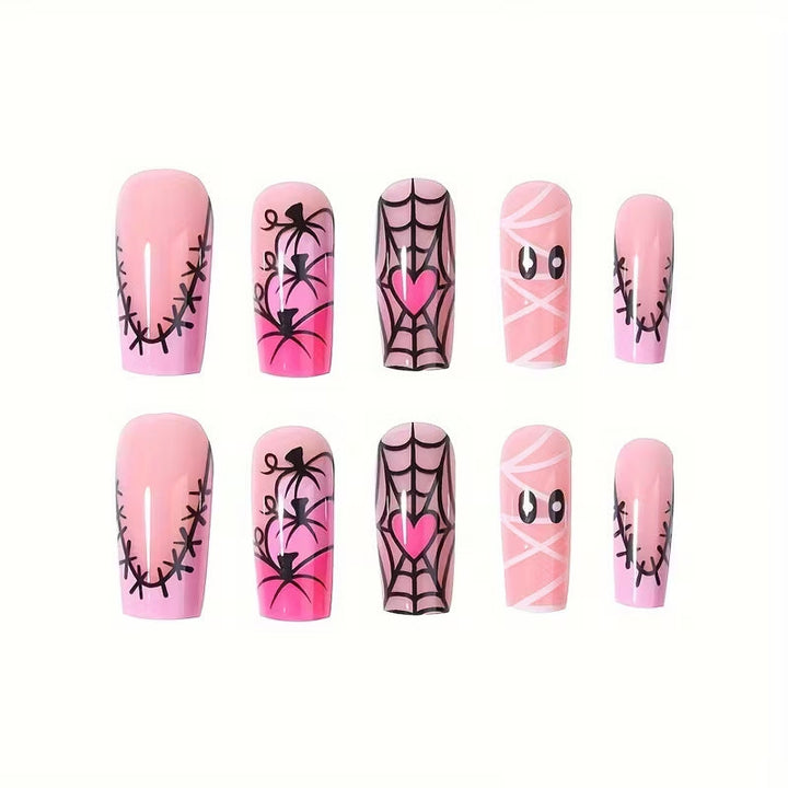 DIY Halloween manicure: black press-on nails with spooky spiderweb & witchy art designs for a festive look.