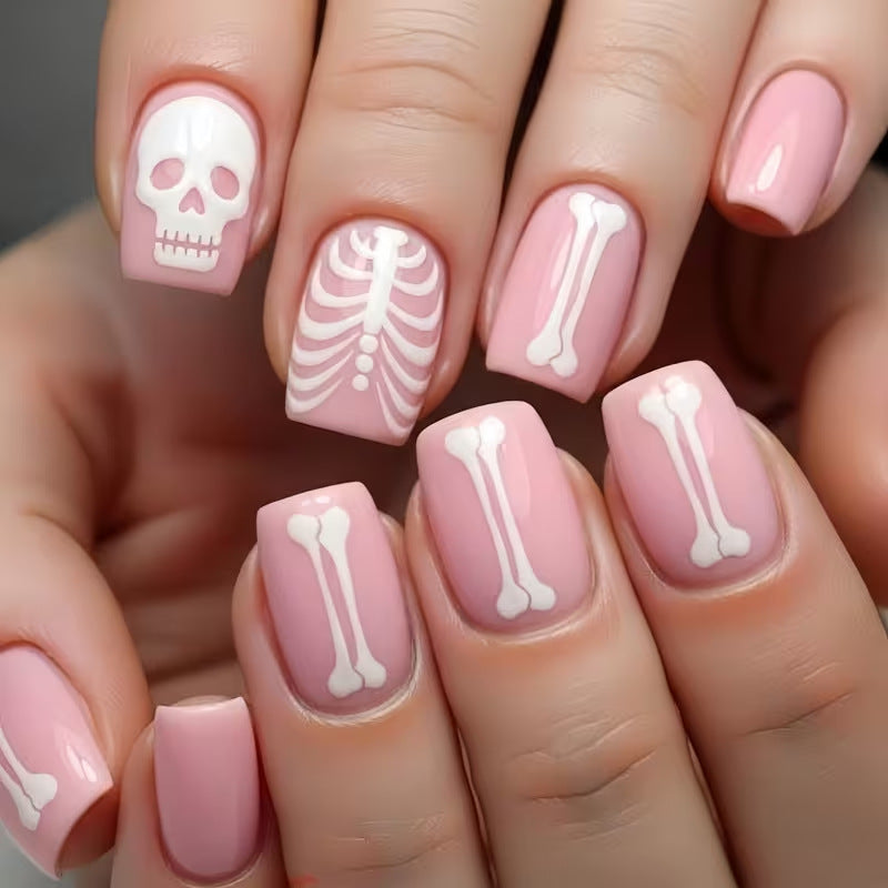 Spooky skeleton nail art set, perfect press-on nails for a Halloween costume accessory with detailed decals.