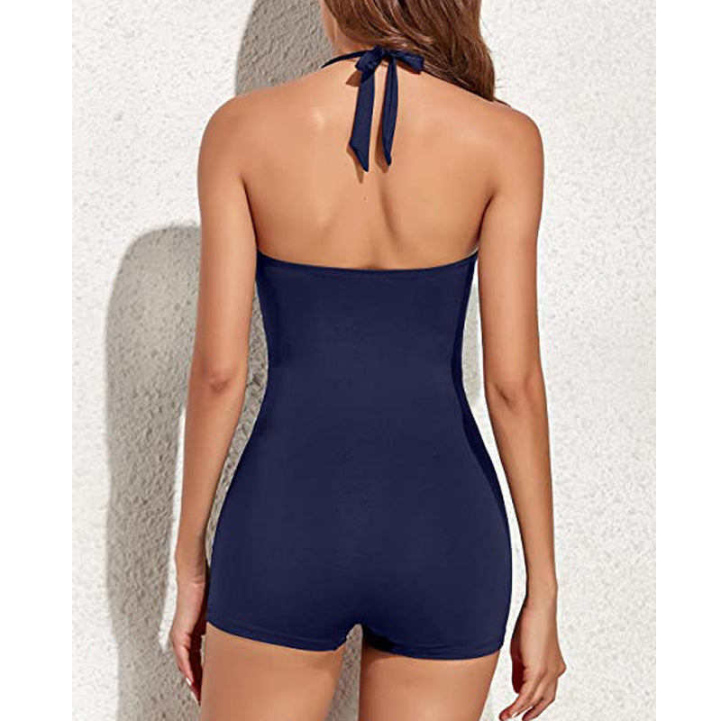 Close-up of women's halter swimsuit: ruched tummy control top & comfortable modest swim shorts for summer.