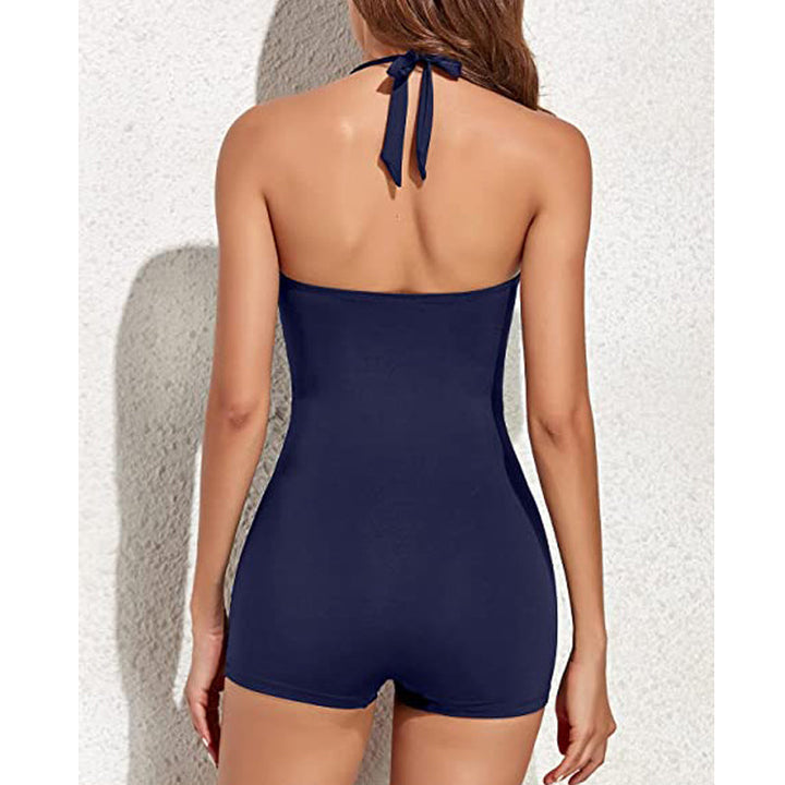 Close-up of women's halter swimsuit: ruched tummy control top & comfortable modest swim shorts for summer.
