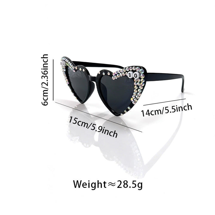 Trendy women's heart-shaped sunglasses, adorned with sparkling rhinestones, offering stylish UV protection.