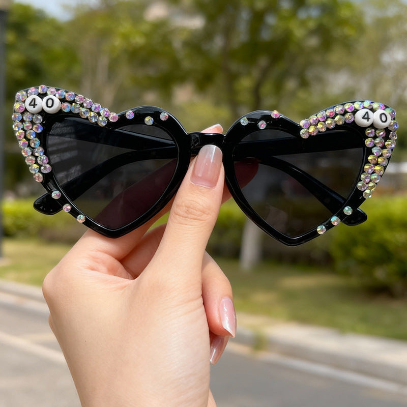 Sparkling women's heart rhinestone eyewear, offering trendy fashion and crucial UV protection for bright days.