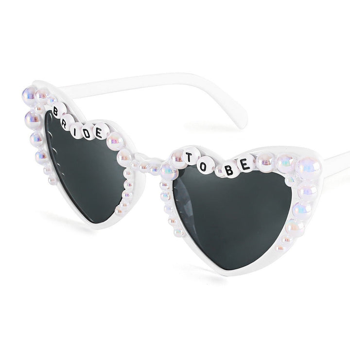 Quirky heart-shaped fashion sunglasses for women, providing essential UV protection for parties.