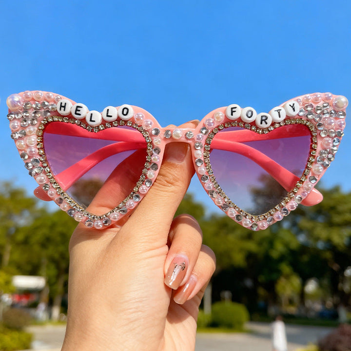 Unique women's heart sunglasses with pearl accents, offering stylish UV protection. Summer fashion.