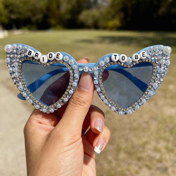Gorgeous women's heart-shaped sunglasses, pearl details, and vital UV protection. Summer ready.