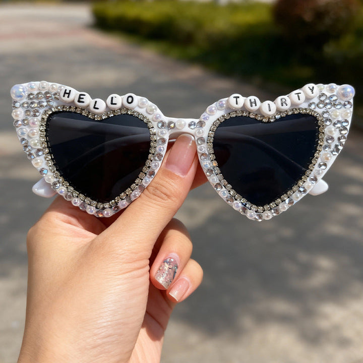 Fashionable women's pearl heart sunglasses. Stylish UV protection eyewear for sun-lovers.