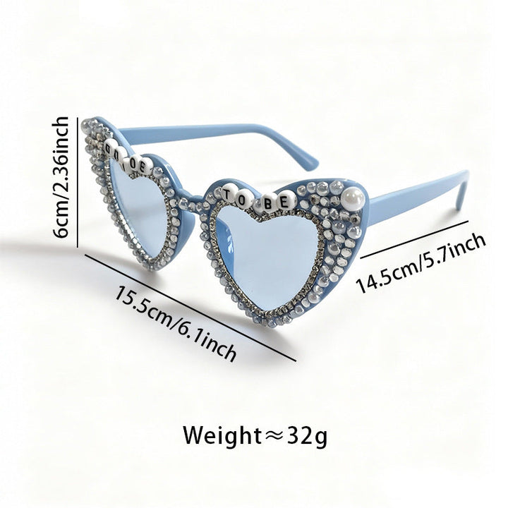 Trendy women's heart sunglasses with pearl accents & UV protection. Fashion eyewear accessory.
