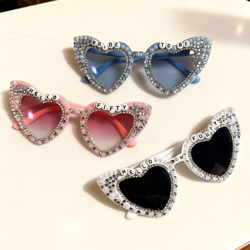 Elegant women's heart sunglasses featuring pearl rim & rhinestone details, full UV protection.