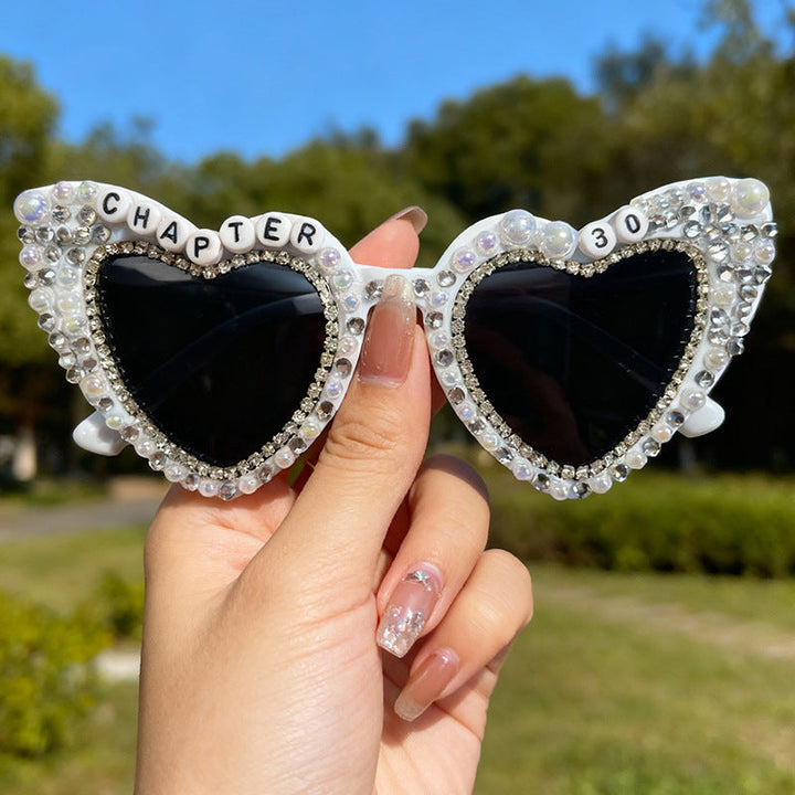 Glamorous women's heart-shaped sunglasses featuring pearls & UV protection. Perfect summer accessory.