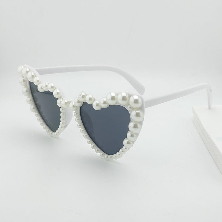 Trendy women's heart pearl sunglasses, a chic summer accessory. Gradient lenses for stylish sun protection.
