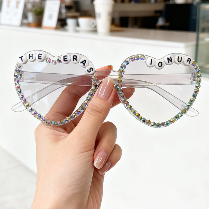 Women's heart-shaped sunglasses with sparkling rhinestones. Glamorous fashion accessory for trendy women.