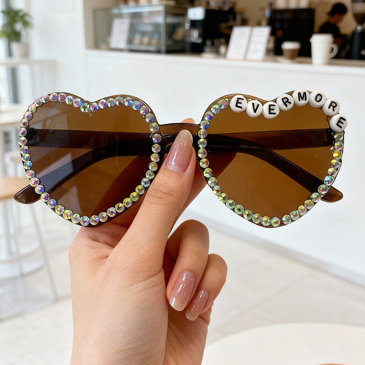 Dazzling rhinestone heart-shaped sunglasses for women. Glamorous, stylish fashion accessory.