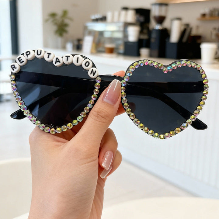 Women's heart rhinestone sunglasses for fashion & UV protection outdoors. Glam & trendy accessory.
