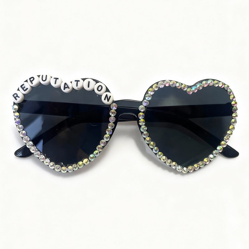 Vibrant heart-shaped rhinestone sunglasses for women. A trendy fashion accessory with glam appeal.