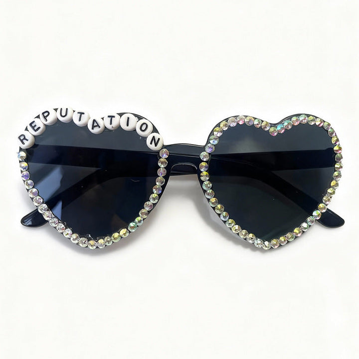 Vibrant heart-shaped rhinestone sunglasses for women. A trendy fashion accessory with glam appeal.