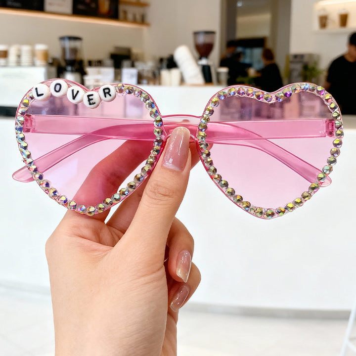 Women's heart-shaped rhinestone sunglasses: glam, stylish, UV protection, trendy fashion accessory.