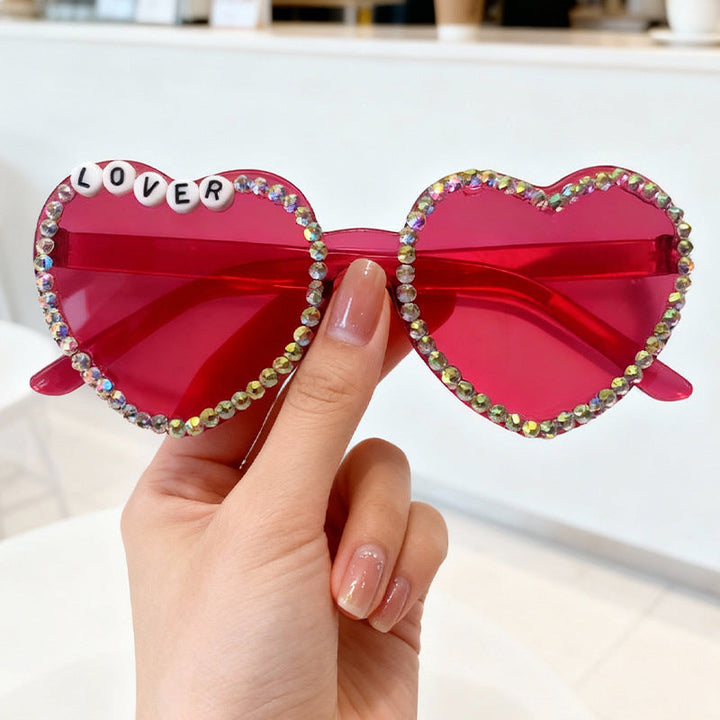 Glam heart-shaped women's sunglasses with dazzling rhinestones. Perfect trendy fashion accessory.