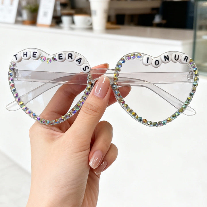 Fashionable heart-shaped rhinestone sunglasses for women. A vibrant, glam accessory for any look.