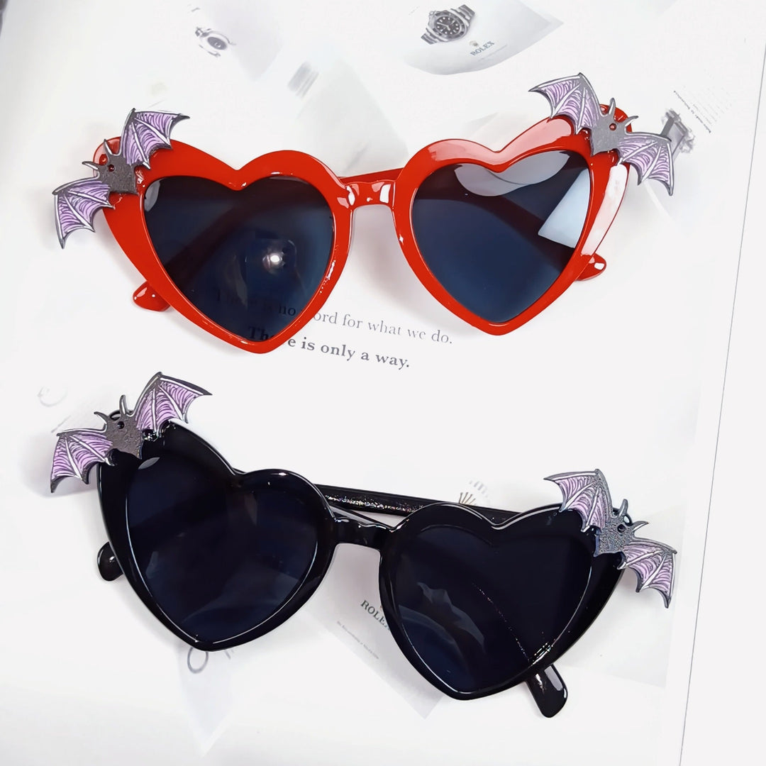 Stylish red heart sunglasses with bat wings, perfect for festivals & parties. Unique women's eyewear.