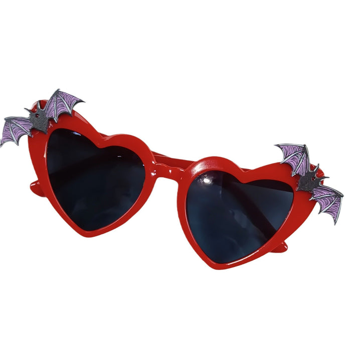 Fashionable women's black heart-shaped sunglasses with cool bat accents, offering style & sun protection.