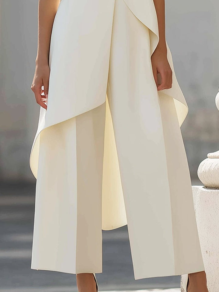 Modern women's high neck asymmetric top & wide-leg pants set, a sophisticated workwear outfit.