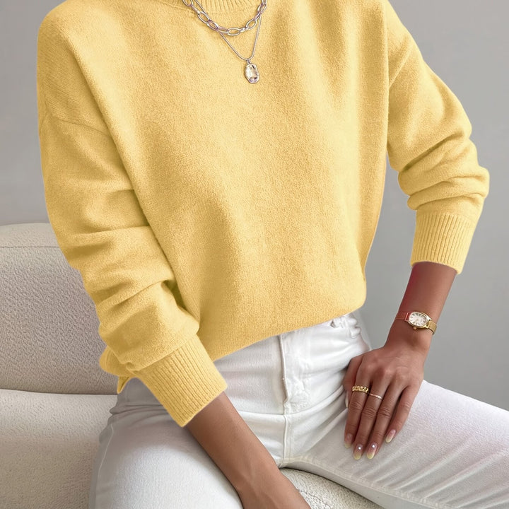 Fashionable ladies' high neck knitted pullover. Cozy, soft, and warm for cold seasons.