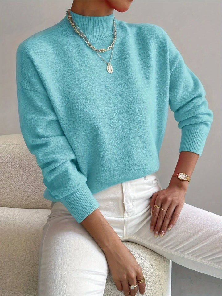 Stylish high neck knitted jumper for women. Perfect autumn winter casual or elegant outfit.