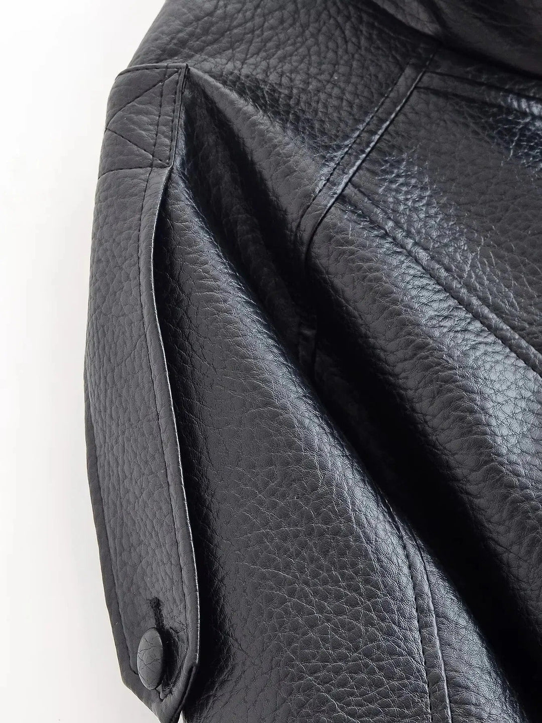 Woman in structured high neck leather jacket, chic moto style, perfect for polished urban everyday fashion.