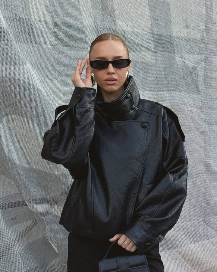 Structured women's moto style leather jacket with high neck, a versatile piece for chic everyday wear.