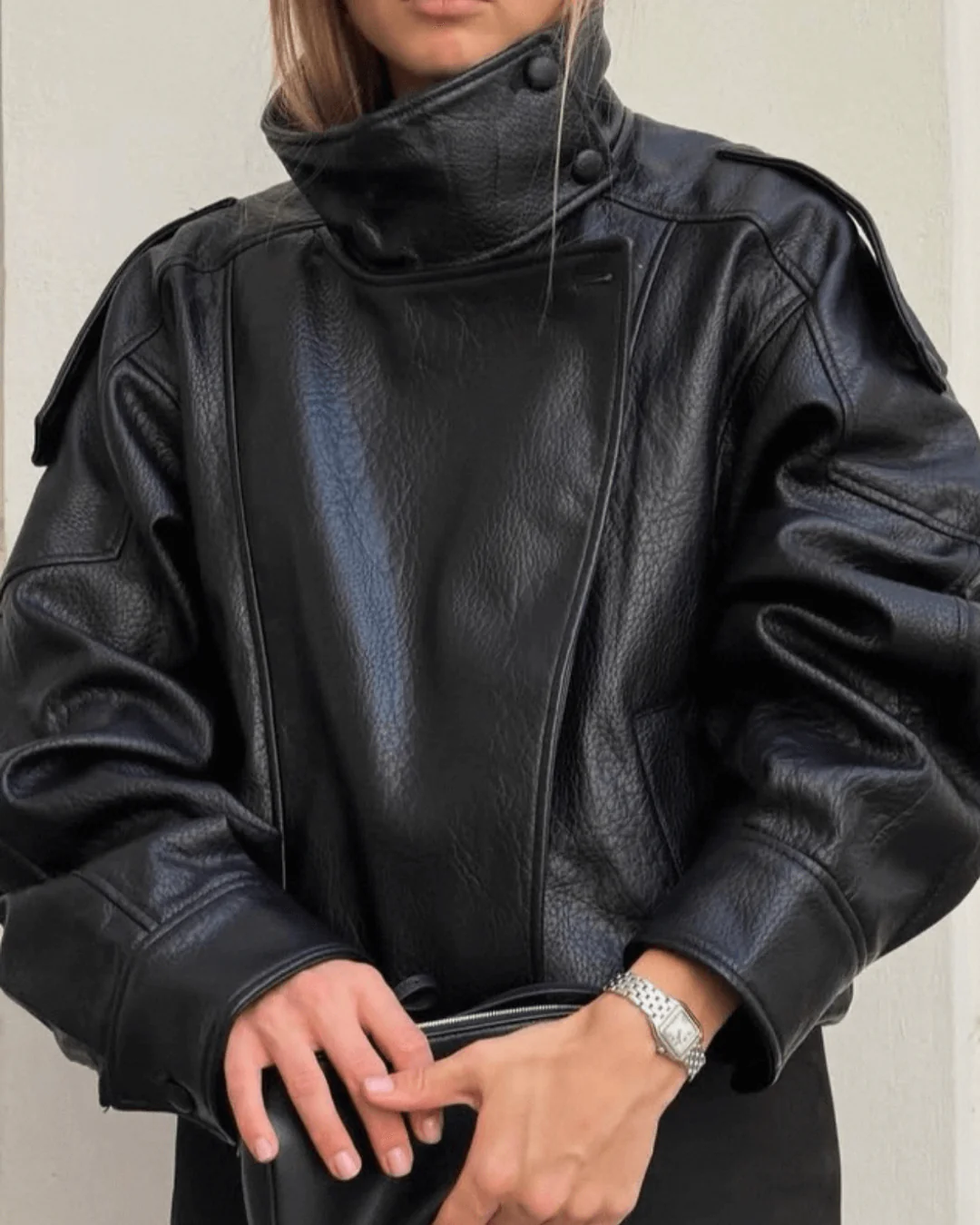 Woman wearing a chic high neck leather jacket, structured and versatile for polished everyday style.