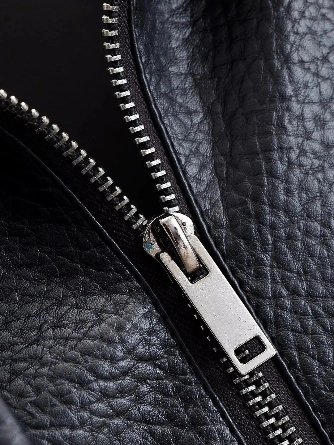 Angled shot of women's structured high neck leather jacket, moto style, perfect for chic everyday wear.