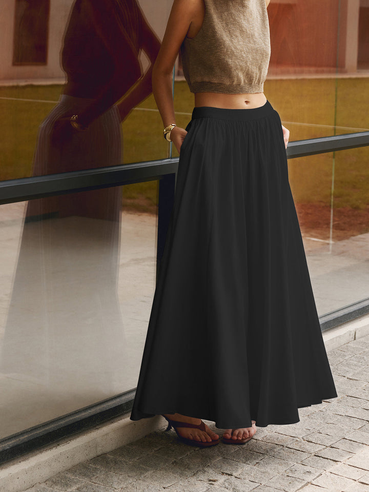 Elegant white A-line maxi skirt with a high waist, perfect for women seeking comfortable, flowy summer fashion.