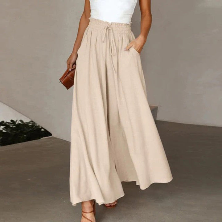 Stylish women's high-waist A-line maxi skirt, perfect for casual wear, with drawstring & pockets.