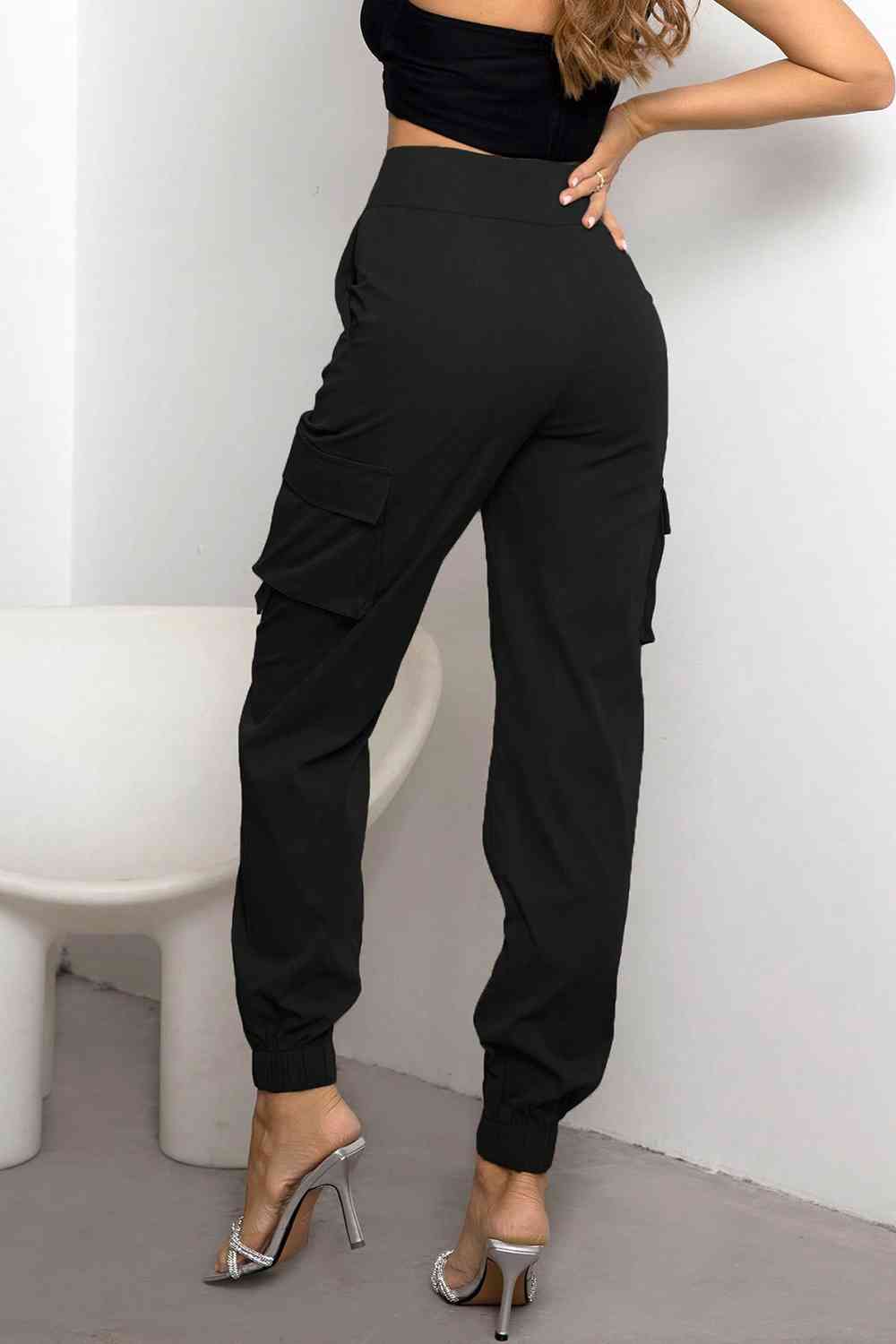 Sleek women's black high-waist cargo pants with practical pockets, ideal for versatile fashion & comfort.