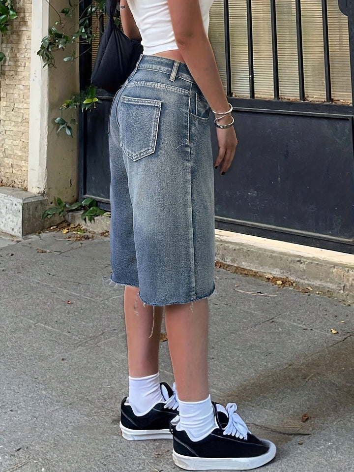 Trendy knee-length denim jorts for women, featuring a comfortable high waist and wide leg design.