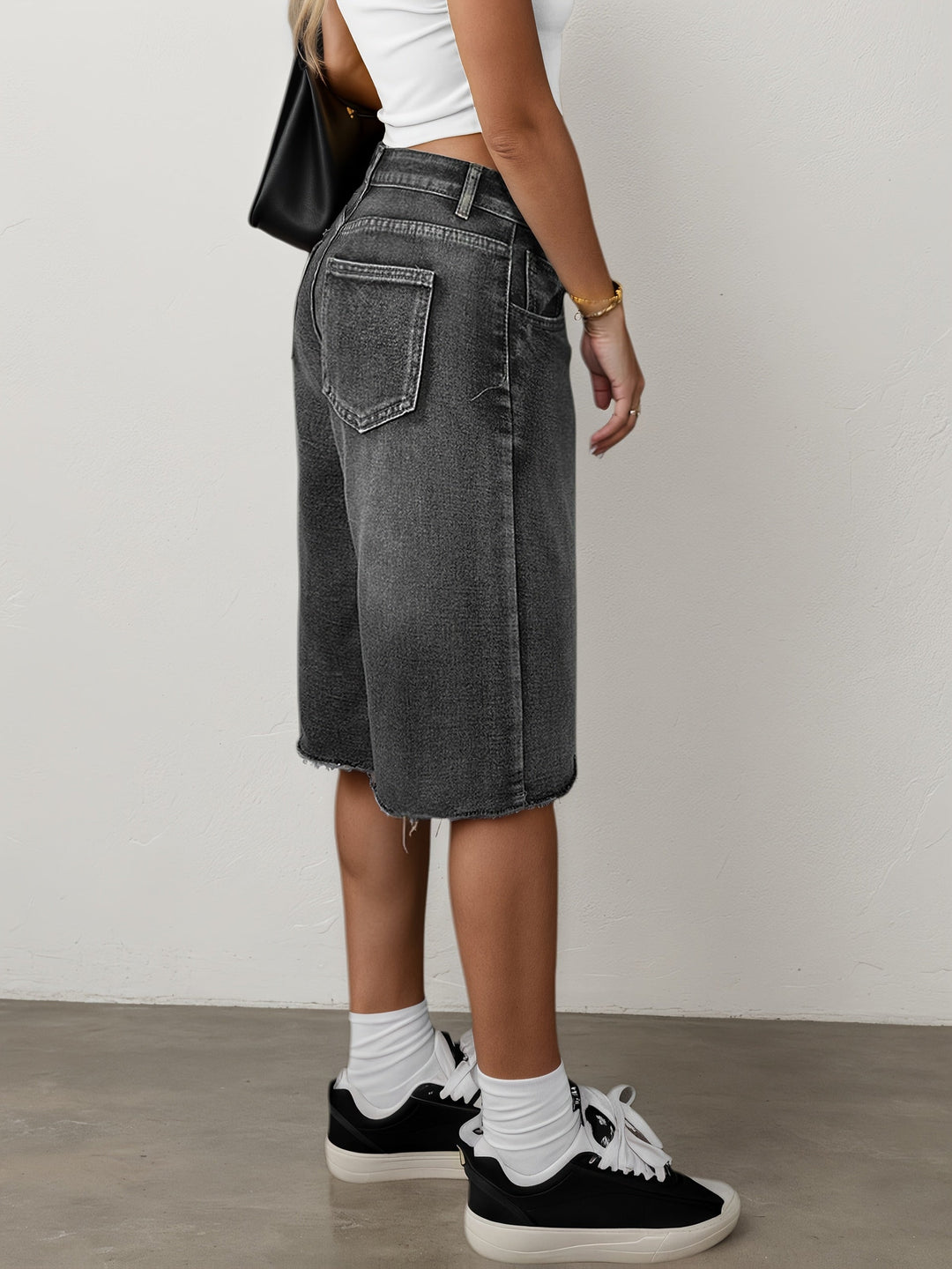 Close-up of women's trendy high waist wide leg jorts, knee length, showcasing the denim fabric.