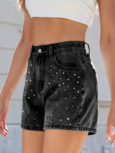 Close-up of dazzling rhinestones on chic high-waist women's shorts, a trendy summer fashion statement.
